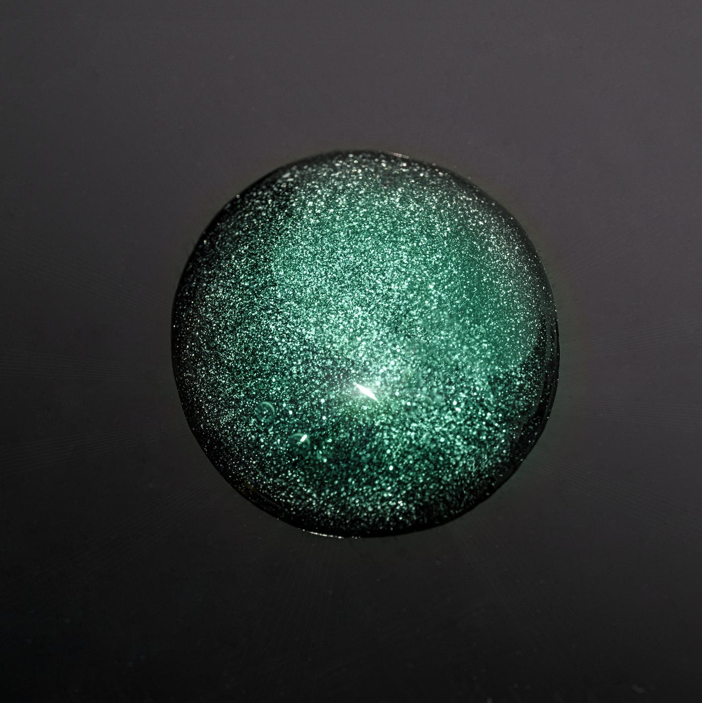 abstract natural beauty product background with smear drop of moisturizing cleaning cosmetic gel or face serum on black color background